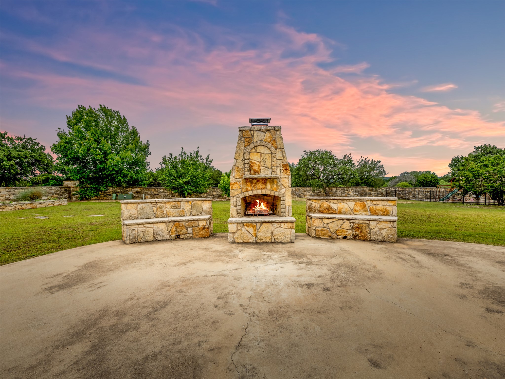 101 Aldea Street Georgetown, TX 78633 - Photo 27 of 40 Enjoy a cool evening with a fire in this custom stone fireplace with custom bench seating.