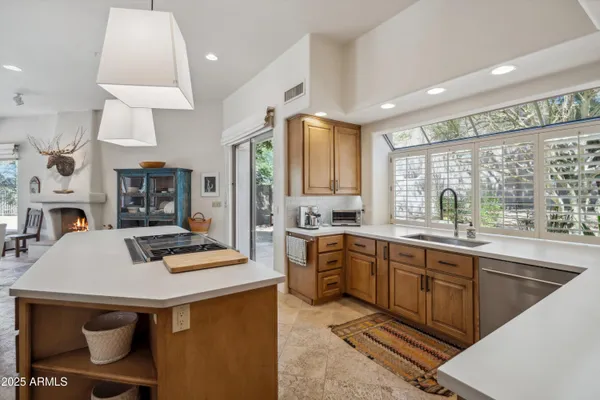 a kitchen with stainless steel appliances granite countertop a sink a stove and a refrigerator
