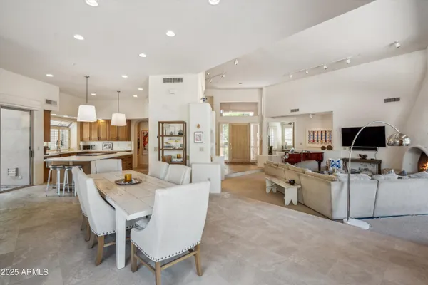 a large white kitchen with a table and chairs