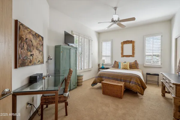 a spacious bedroom with a bed and a desk