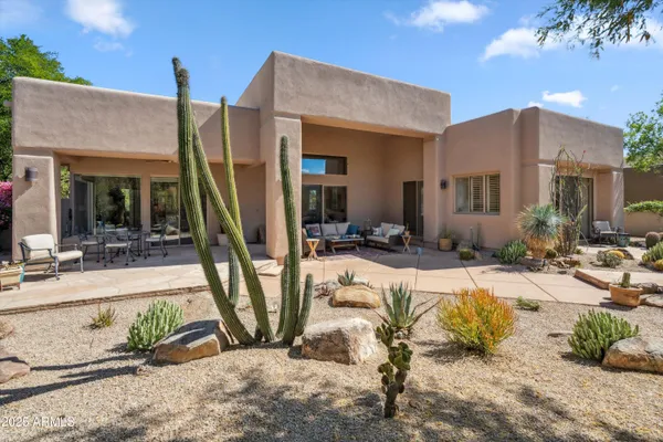 a view of a house with backyard and sitting area