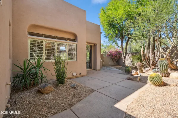 a view of potted plants in front of house
