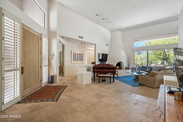 a view of living room filled with furniture and a large window
