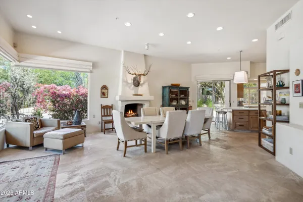 a living room with furniture a fireplace and a table