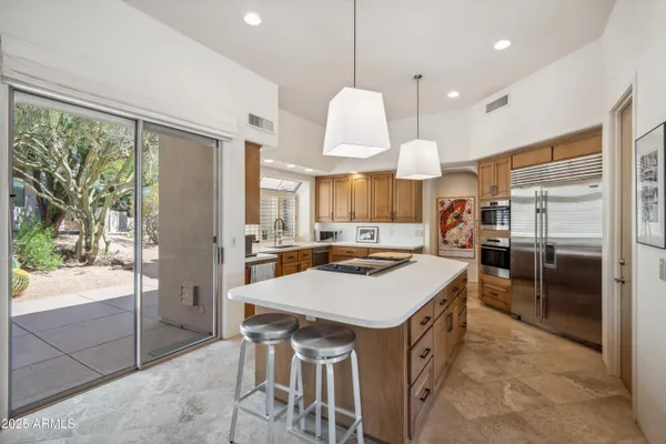 a kitchen with a sink a counter top stainless steel appliances and cabinets