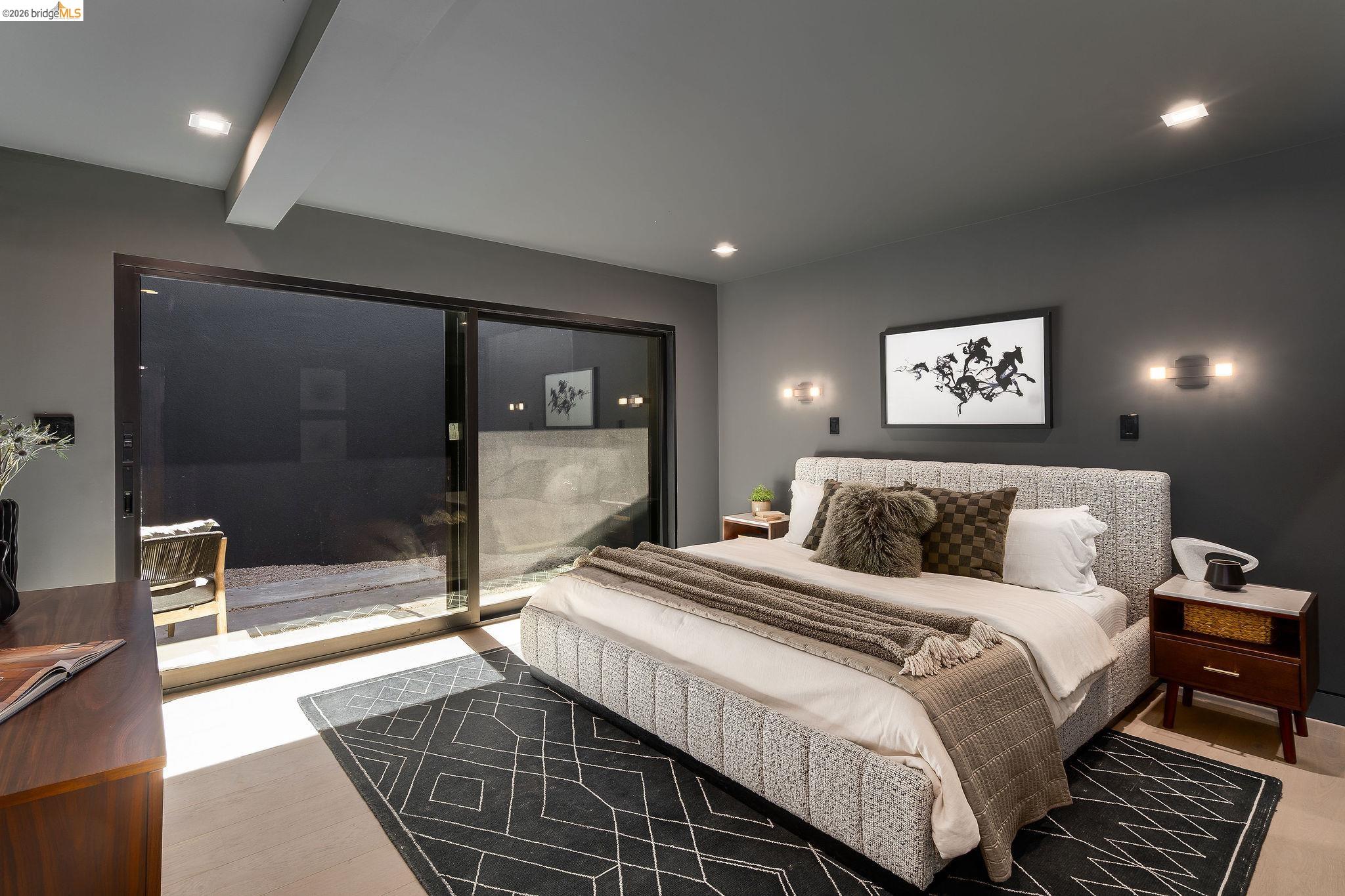5645 Bacon Road Oakland, CA 94619 - Photo 48 of 94 Bedroom featuring a sliding glass door, recessed lighting, wall sconces, light wood-finish flooring, and a dark accent wall