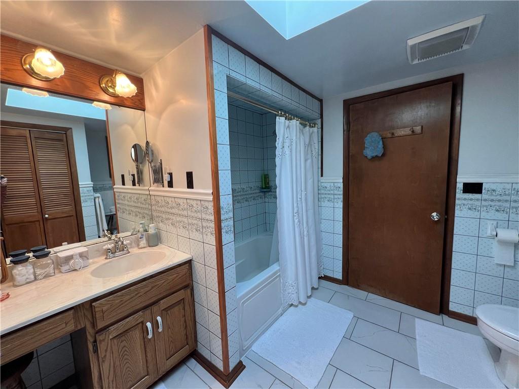 1214 Slate Point Road Vandergrift, PA 15690 - Photo 21 of 47 a bathroom with a sink a mirror and a shower