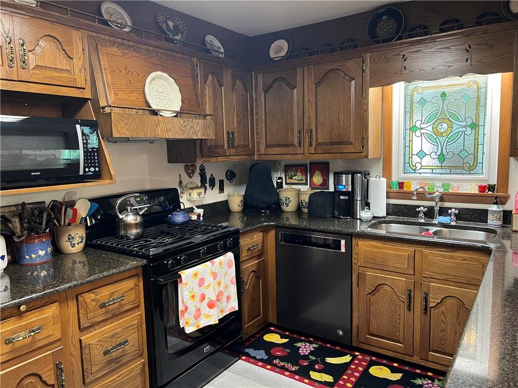 1214 Slate Point Road Vandergrift, PA 15690 - Photo 3 of 47 a kitchen with stainless steel appliances granite countertop a stove a sink and a microwave