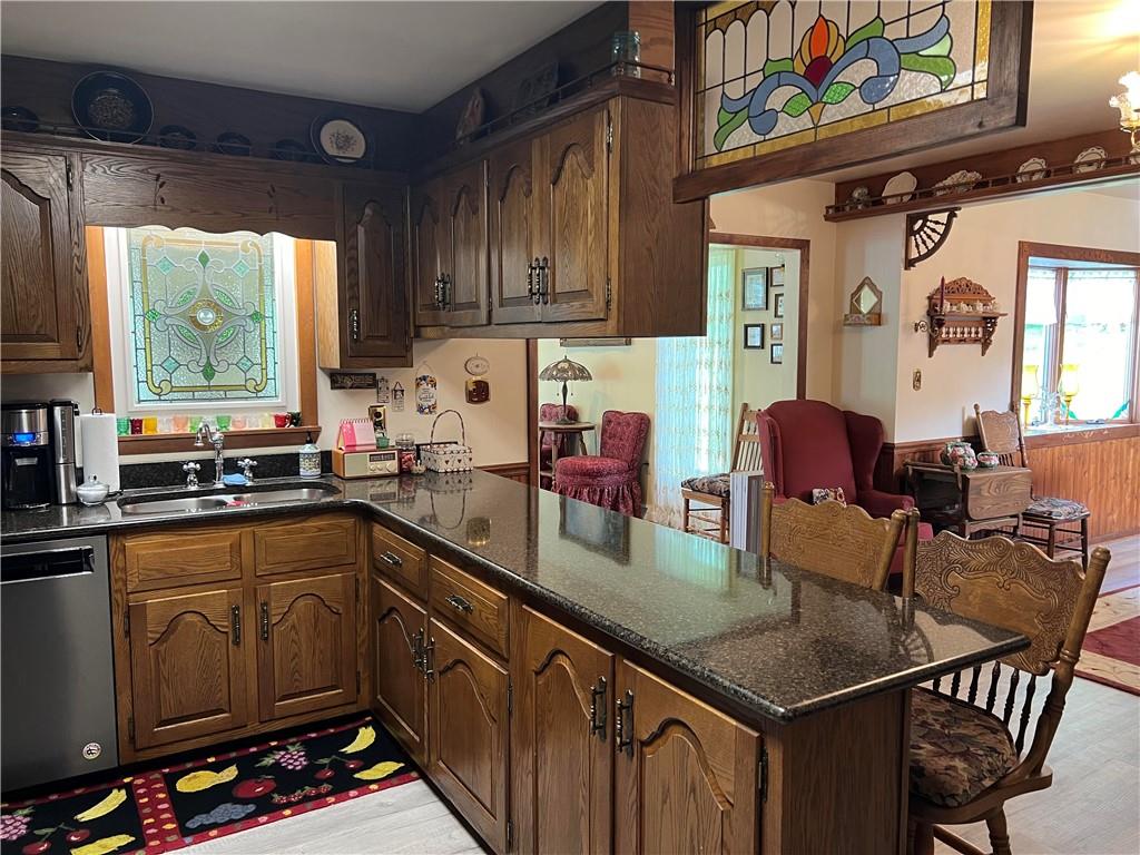 1214 Slate Point Road Vandergrift, PA 15690 - Photo 4 of 47 a kitchen with stainless steel appliances granite countertop a stove a sink dishwasher and cabinets with wooden floor
