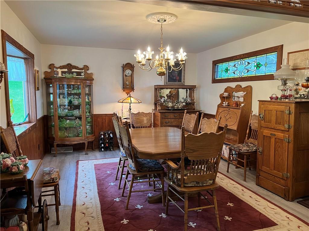1214 Slate Point Road Vandergrift, PA 15690 - Photo 6 of 47 a view of a dining room with furniture a chandelier and wooden floor