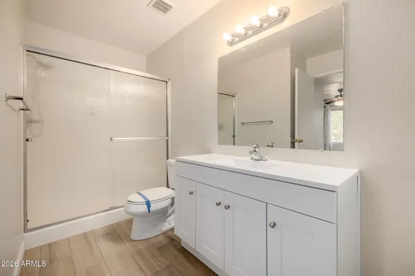 a bathroom with a double vanity sink mirror and toilet