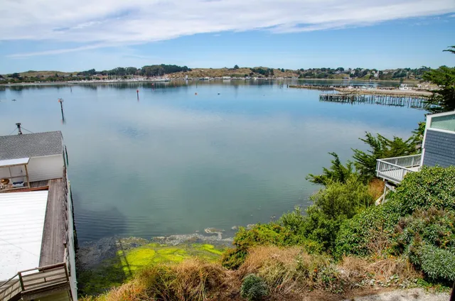 an aerial view of a house with a lake view