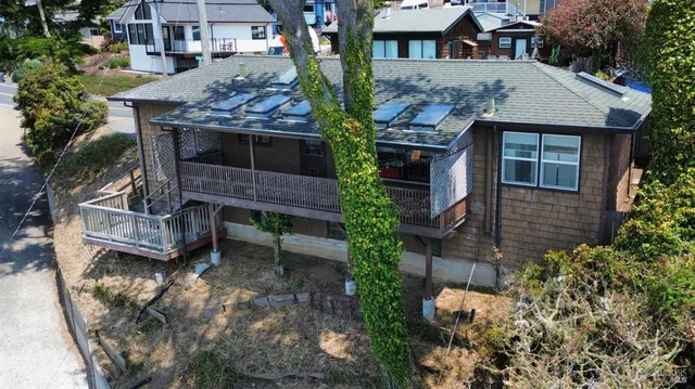 a view of a house with brick walls and potted plants
