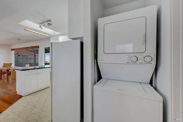 a view of hallway with closet and wooden floor