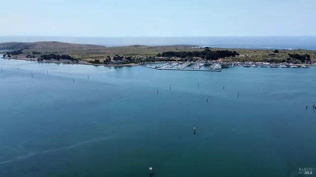 an aerial view of a residential houses with outdoor space and swimming pool