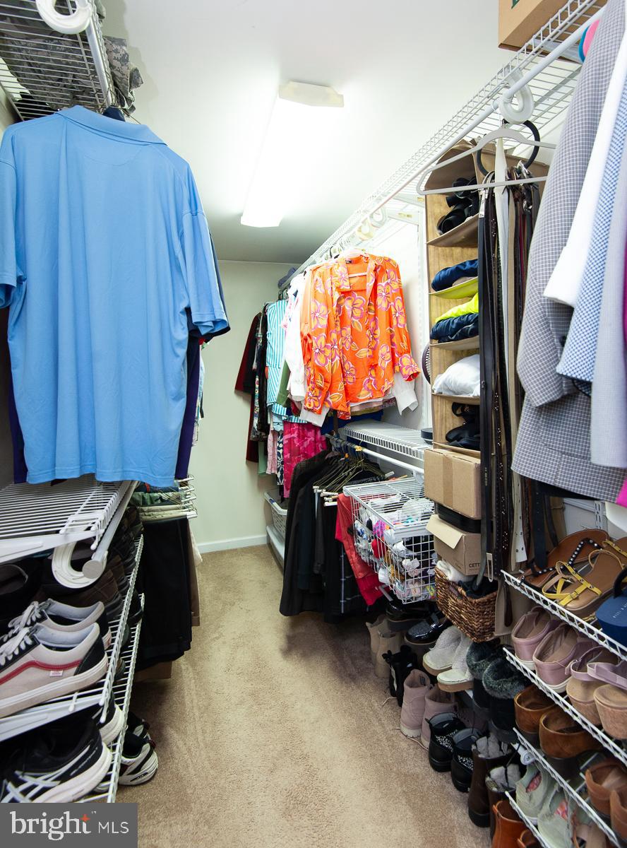 12136 Holly Road Ridgely, MD 21660 - Photo 52 of 136 a view of walk in closet with clothes and shoes