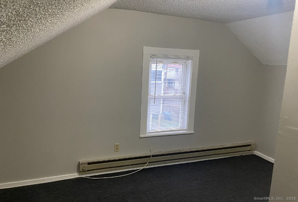 Undisclosed Address Bridgeport, CT 06610 - Photo 5 of 8 an empty room with wooden floor and windows