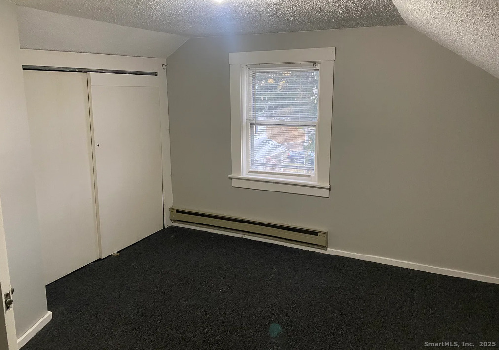 Undisclosed Address Bridgeport, CT 06610 - Photo 6 of 8 an empty room with wooden floor and windows