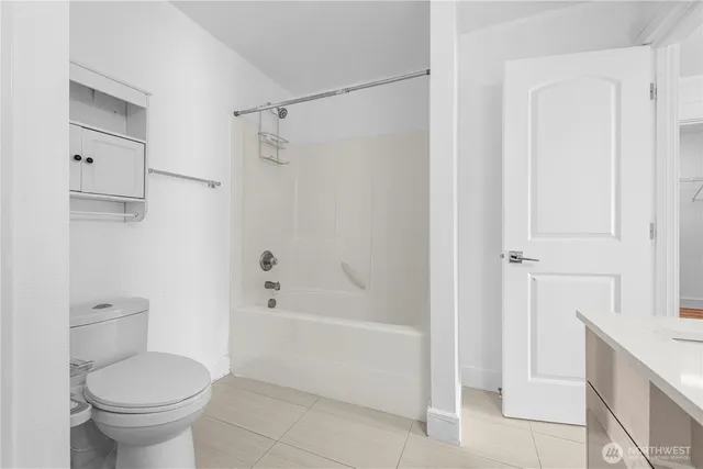 a bathroom with a toilet and a bathtub
