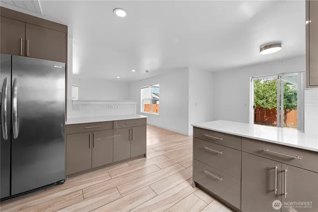 a kitchen with a refrigerator and window