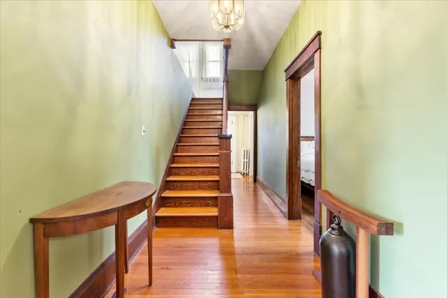 a bedroom with furniture and a large window