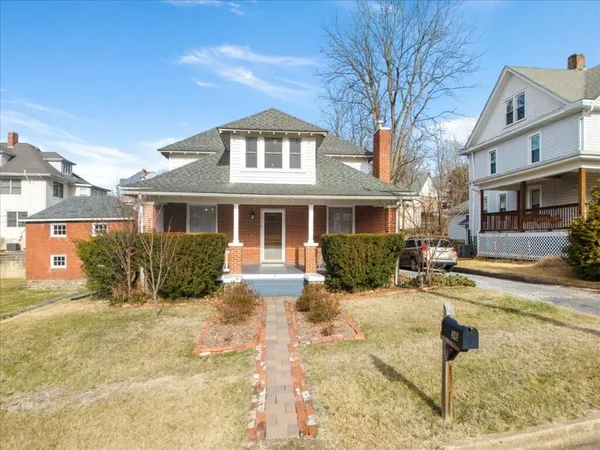 a view of a house with a yard patio and fire pit