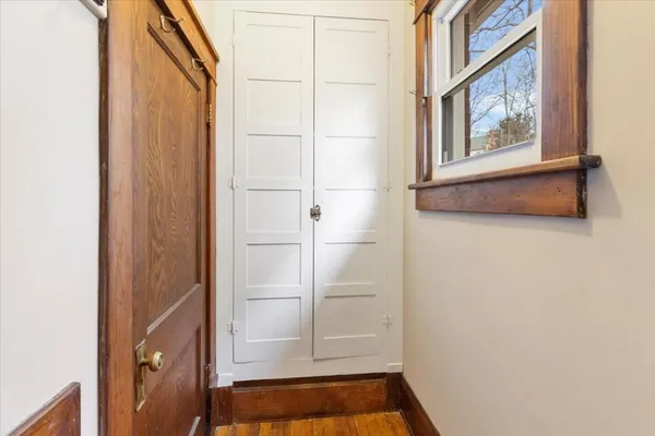 a view of a hallway with wooden floor and stairs
