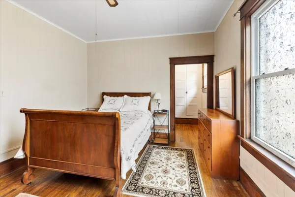 a spacious bedroom with a bed and a window