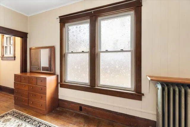 a view of room with window and wooden floor