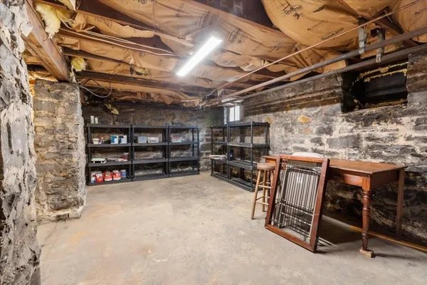 a view of a house with a wooden fence next to a yard