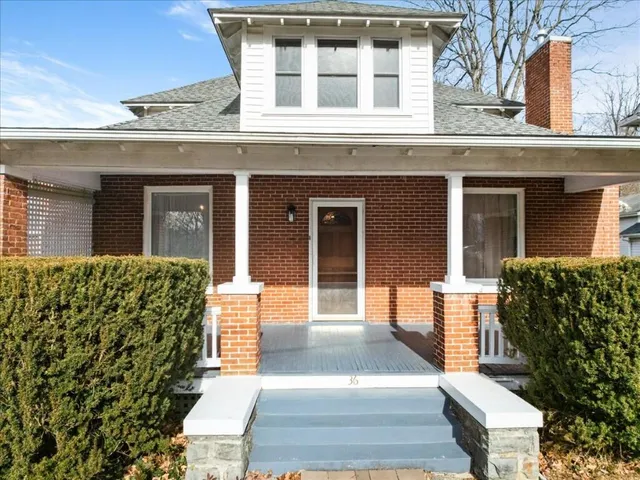 front view of a brick house with a large windows