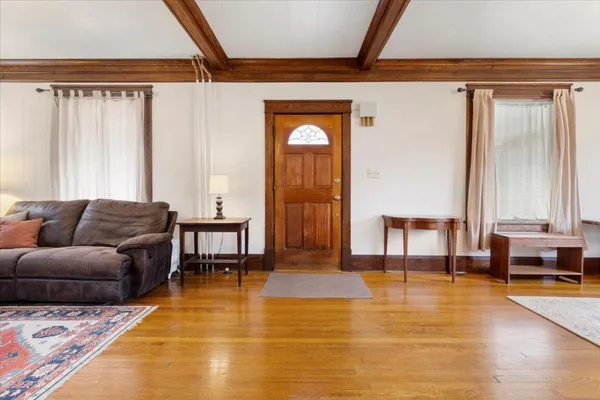 a living room with furniture fireplace and window