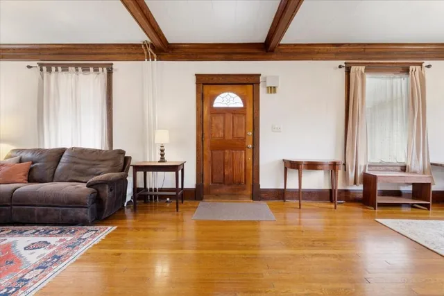 a living room with furniture fireplace and window