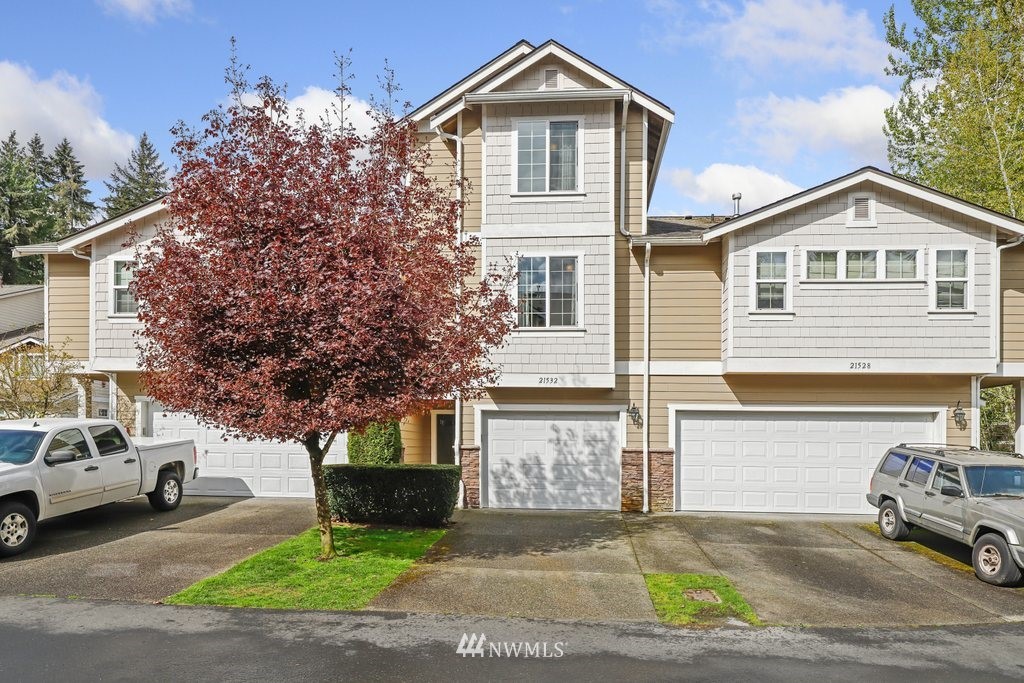 21532 11th Court Southeast Bothell, WA 98021 - Photo 1 of 36 a front view of a house with a yard and garage