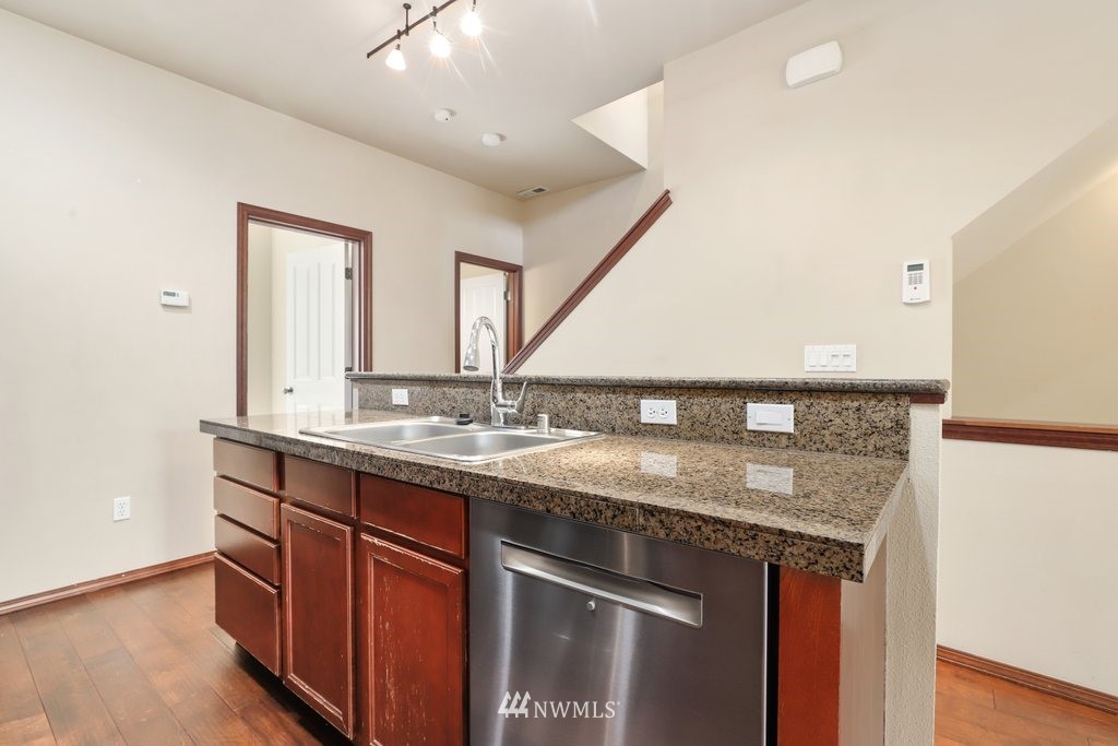 21532 11th Court Southeast Bothell, WA 98021 - Photo 12 of 36 a bathroom with a granite countertop sink and a mirror