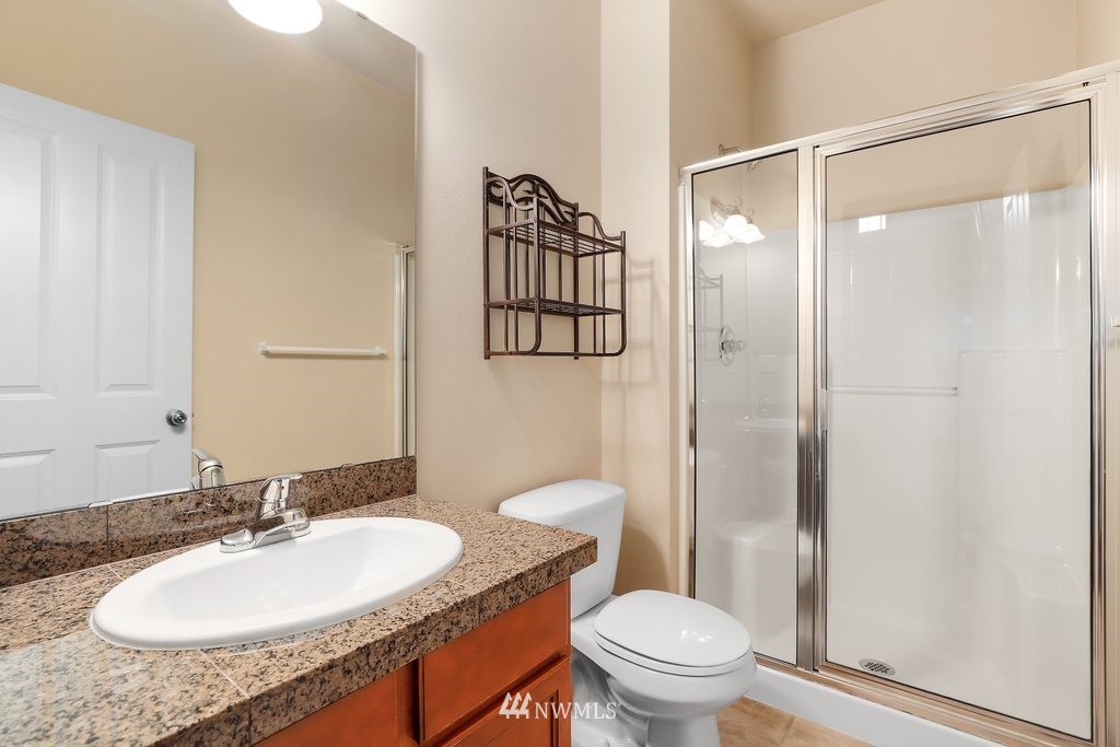 21532 11th Court Southeast Bothell, WA 98021 - Photo 14 of 36 a bathroom with a granite countertop sink toilet and shower