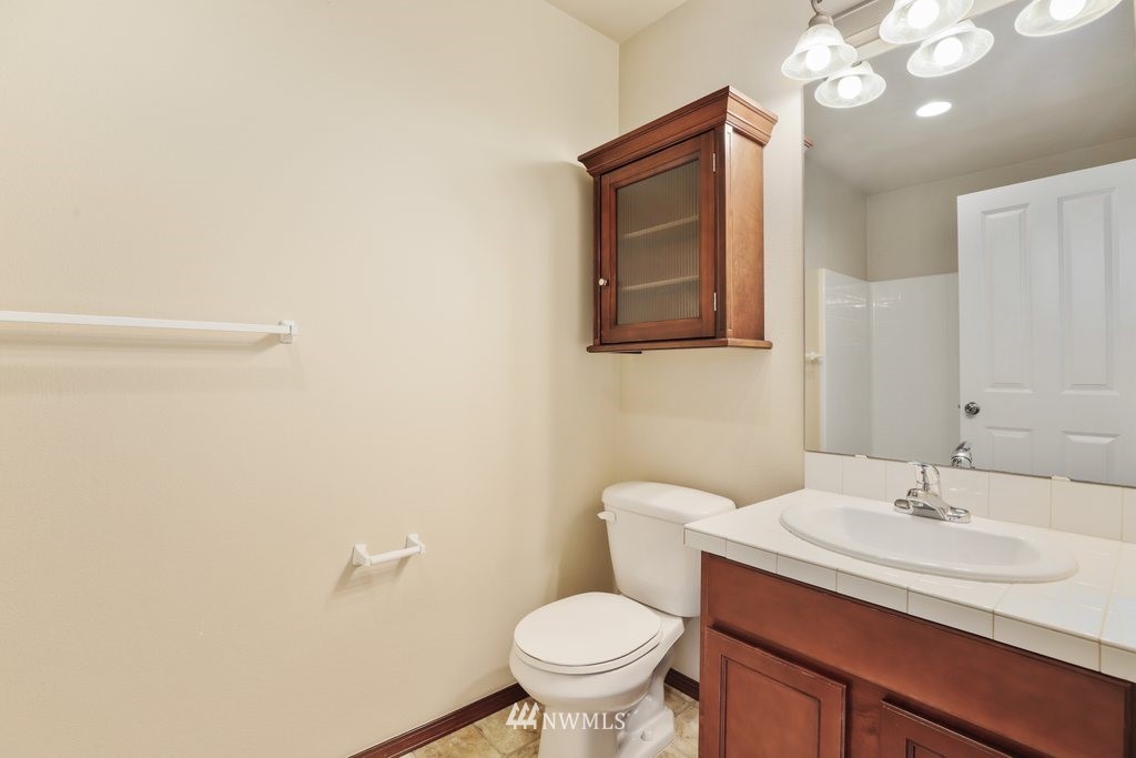 21532 11th Court Southeast Bothell, WA 98021 - Photo 24 of 36 a bathroom with a toilet sink and mirror