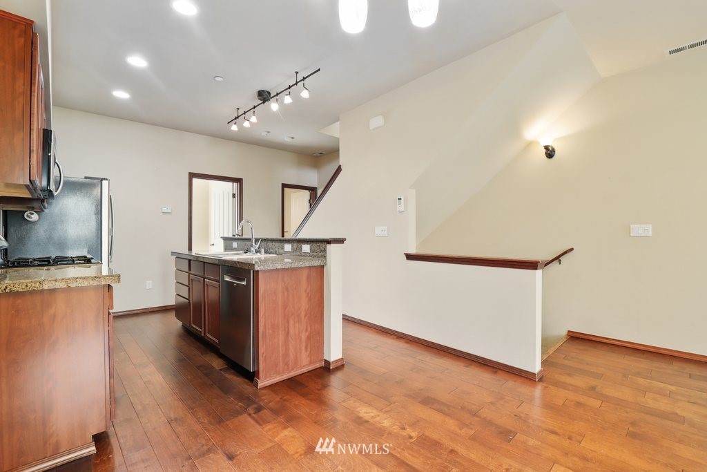 21532 11th Court Southeast Bothell, WA 98021 - Photo 9 of 36 a view of kitchen with refrigerator and wooden floor