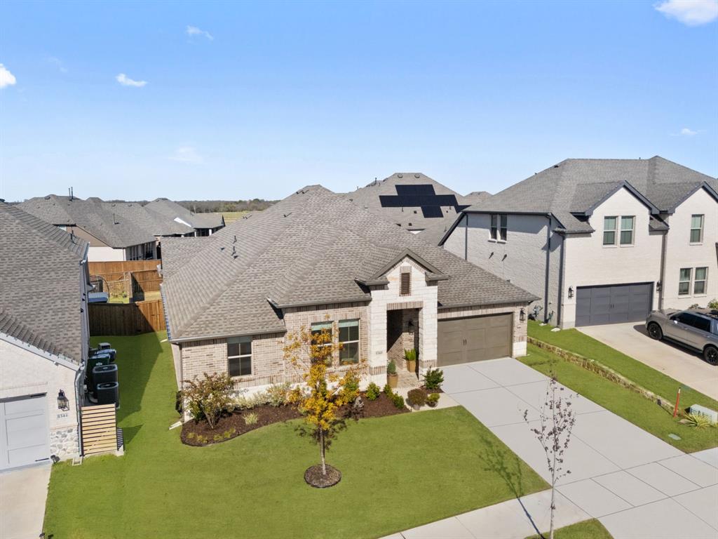 1340 Cartona Road Fate, TX 75087 - Photo 27 of 32 a front view of a house with garden