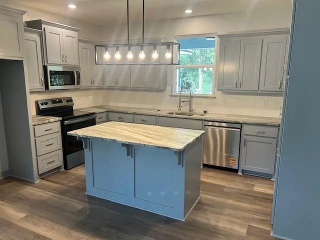 a kitchen with a sink stove and microwave