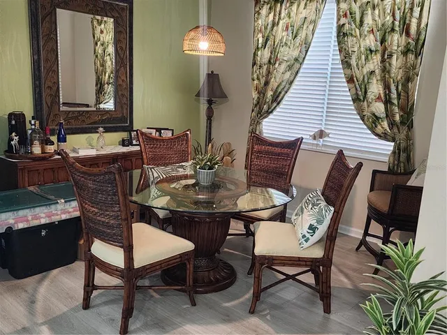 a view of a dining room with furniture and wooden floor