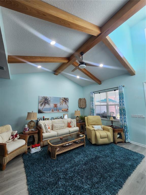 218 Ocean Hammock Loop Daytona Beach, FL 32124 - Photo 7 of 13 a bedroom with furniture and a chandelier