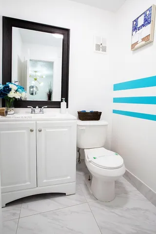 a bathroom with a toilet a sink and a mirror