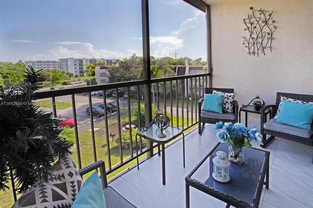 a view of a chairs and table in patio