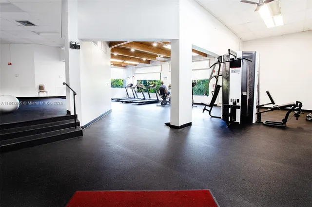 a view of a swimming pool with a bench and trees in the background