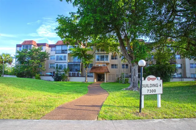 a front view of a house with a garden and plants