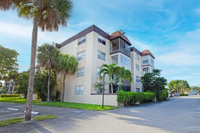 an aerial view of a house with a yard and garden