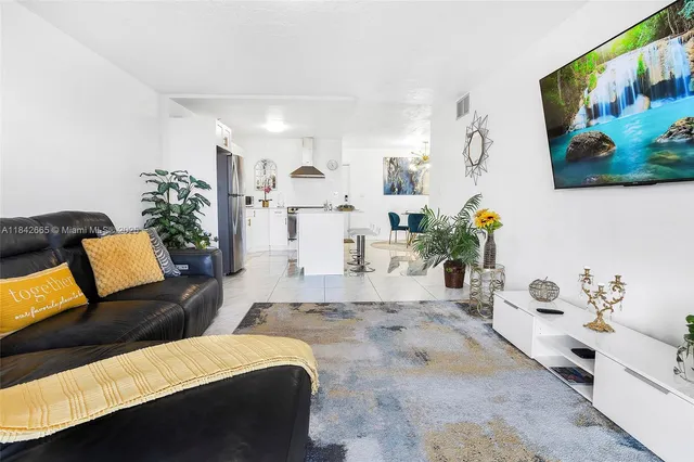 a living room with furniture and painting on the wall