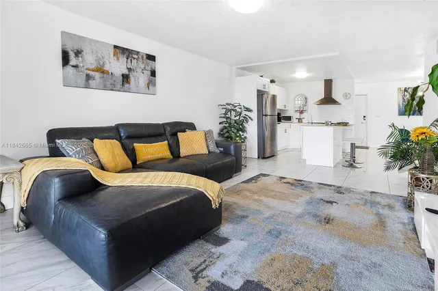 a bedroom with a bed and flowerpot