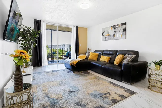 a living room with furniture flowerpot and wooden floor